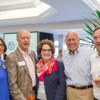 Group of five guests posing with arms around each other at Naples 2019